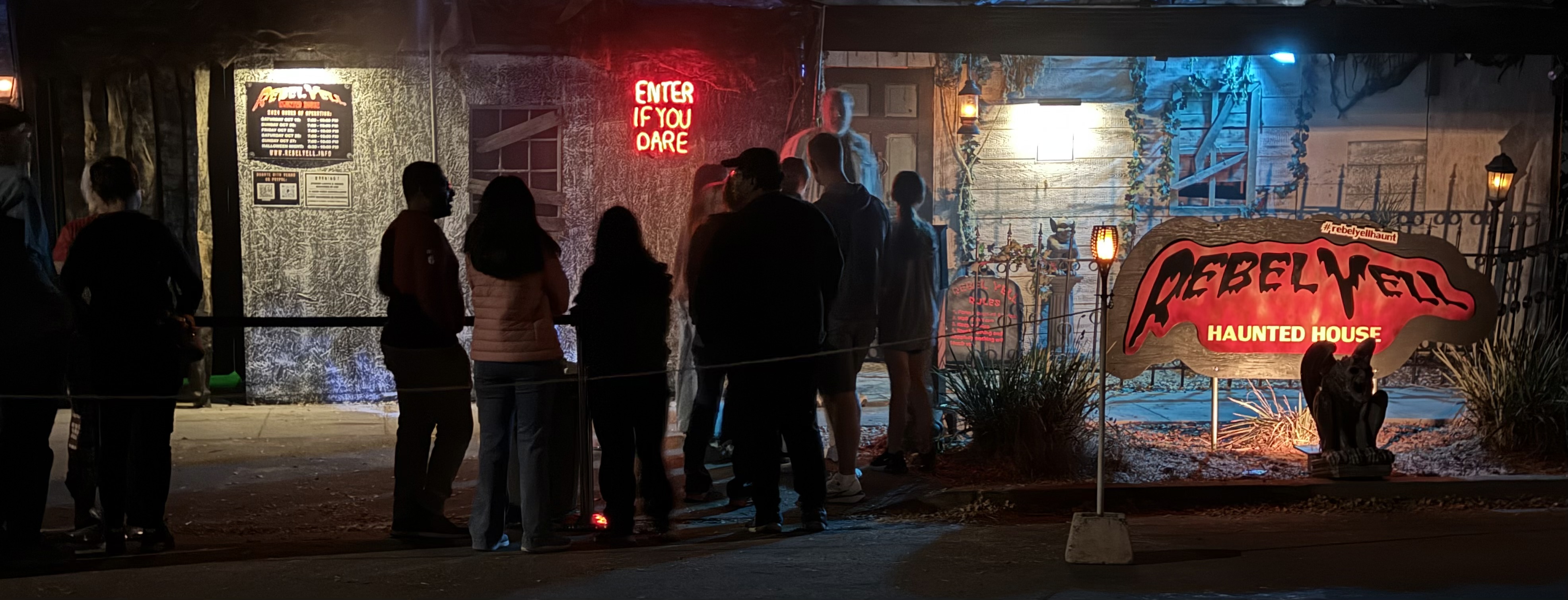 people waiting in line at a haunted house